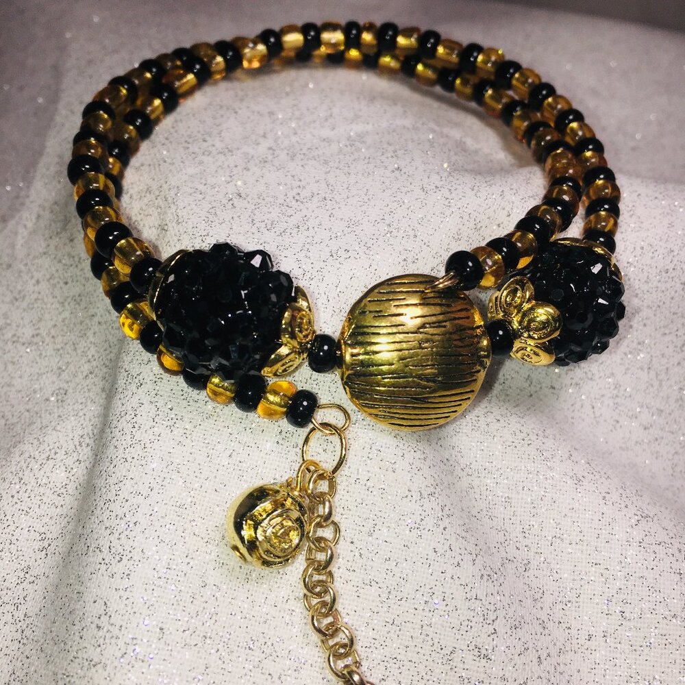 Gold & Black Memory Wire Bracelet with a Gold Rose Charm
